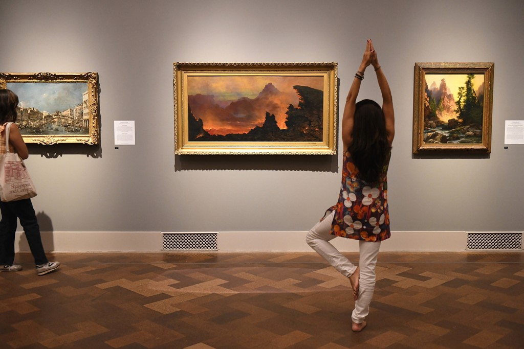 Woman doing a yoga pose inside museum gallery