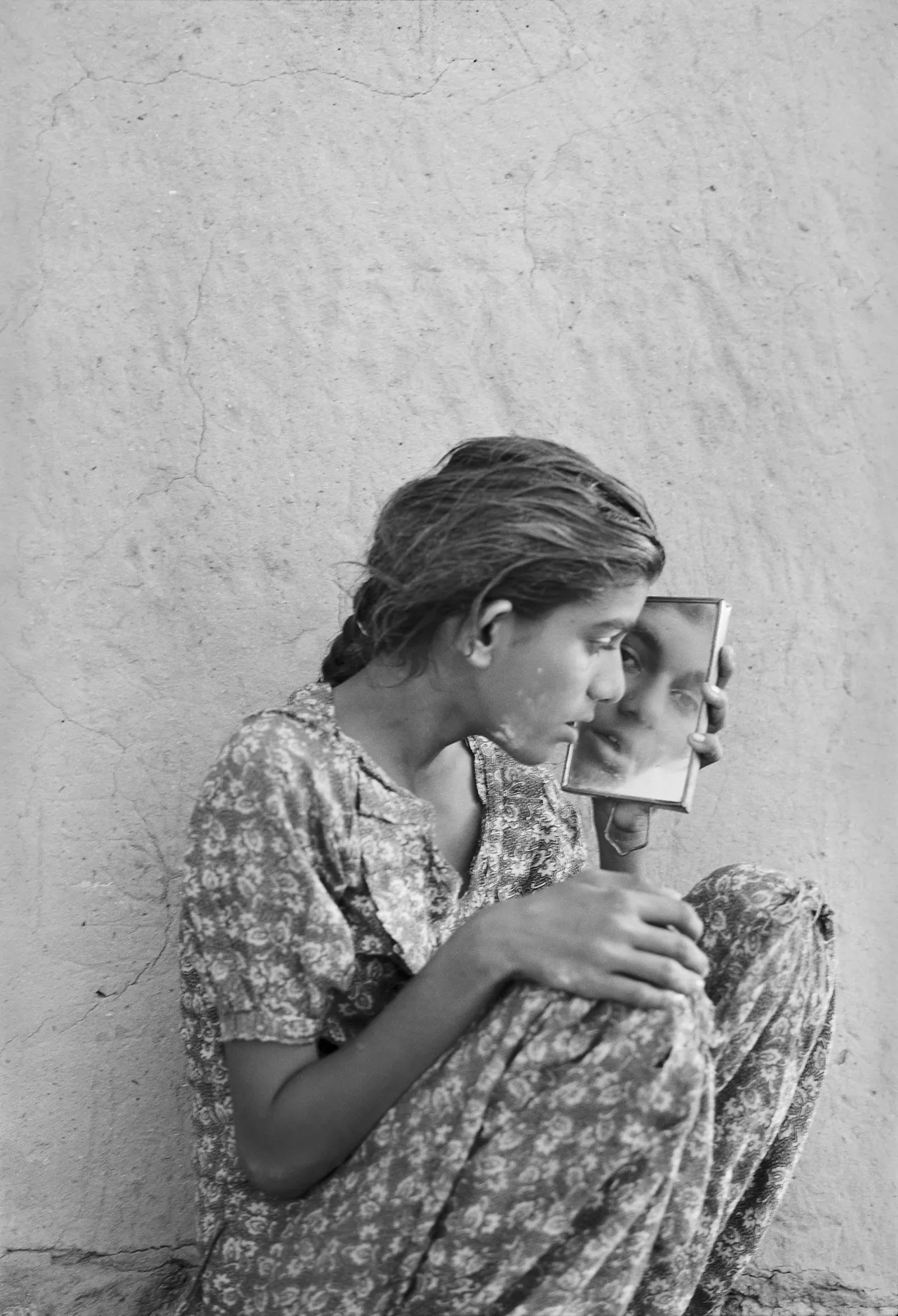 Woman looking into handheld mirror