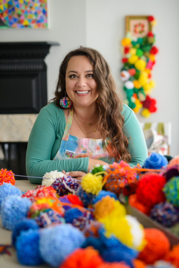 Artist Katie Ruiz with handmade pompoms